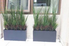 Artificial grass arrangements on a ground level condo terrace in mid-town Toronto